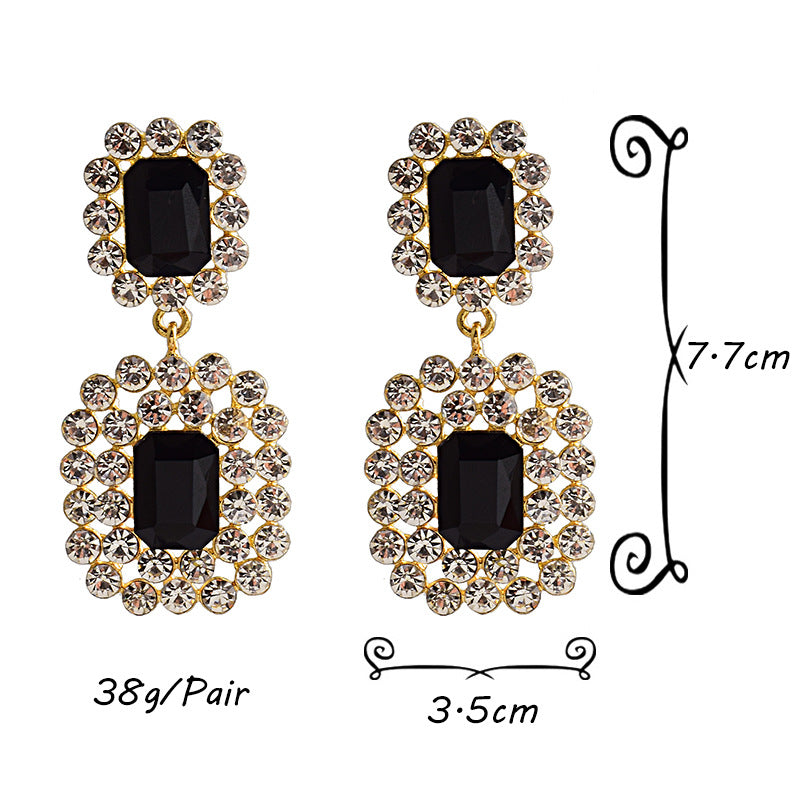 Fashion earrings with large diamonds set in round geometric water droplets