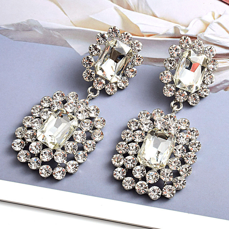 Fashion earrings with large diamonds set in round geometric water droplets