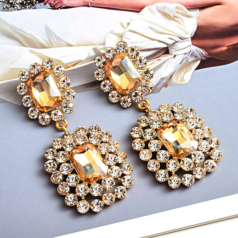 Fashion earrings with large diamonds set in round geometric water droplets