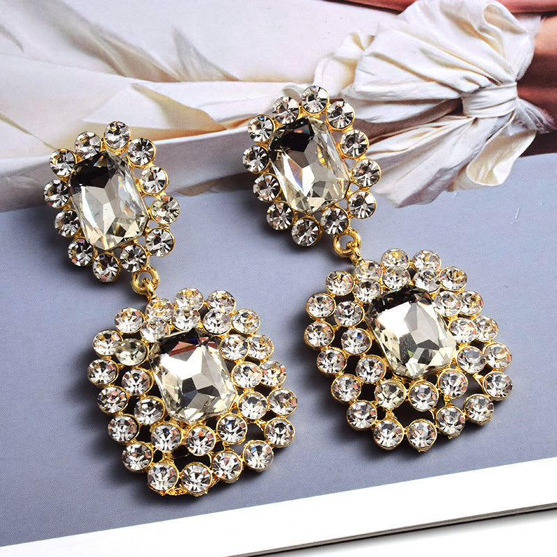 Fashion earrings with large diamonds set in round geometric water droplets
