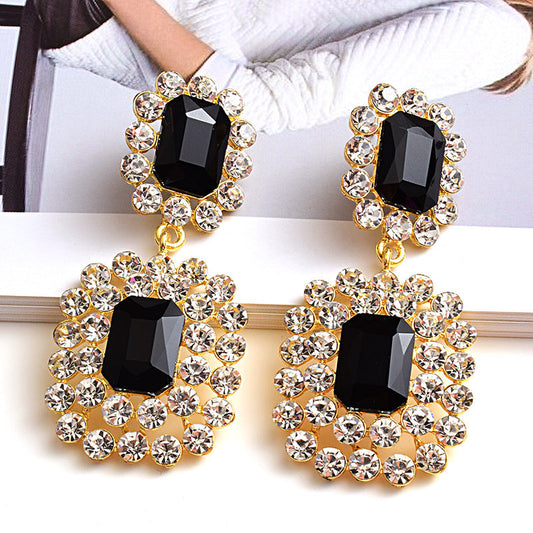 Fashion earrings with large diamonds set in round geometric water droplets